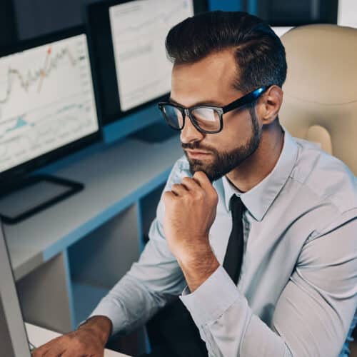 A financial analyst reviews a dashboard displaying transaction analytics, filters, and payment history for lenders.