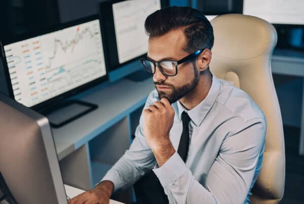 A financial analyst reviews a dashboard displaying transaction analytics, filters, and payment history for lenders.